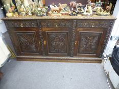 19th Century heavily carved continental oak dresser base with 3 drawers above cupboards