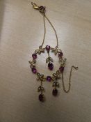 Pretty Victorian circular floral design pendant set with seed pearls and amethyst. marked 9ct in a b