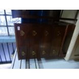 Small mahogany chest of 4 small drawers with brass pulls and a matching two drawer bedside table