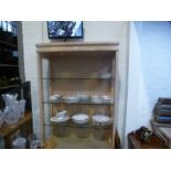 A modern limed effect sideboard having three cupboard doors, a matching glazed display cabinet and s