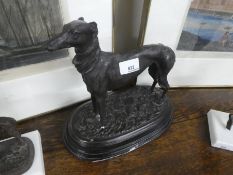 A reproduction bronzed sculpture of greyhound an oval base