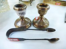 A pair of silver candlesticks hallmarked Birmingham 1975, PH Vogel & Co. Height approx 7cm, toogethe