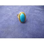 Unmarked yellow gold dress ring with large oval turquoise stone, marks worn, gross weight 6.7g, size