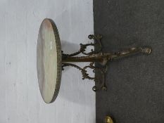 Ornate circular brass revolving coffee table with onyx top