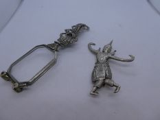 Siamese silver brooch of a dancing Hindu god and a pair of silver and marcasite folding spectacles