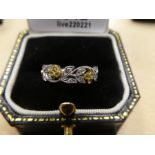 18ct white gold floral design ring inset with yellow sapphires and diamonds, marked 750, gross weigh