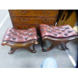Pair of red leather buttoned footstools on x frames supports