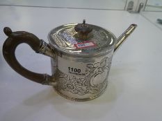 A very decorative George III teapot with foliate embossed design, a carved wooden handle and knob. A