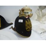 Officers parade ground dress helmet bearing Victoria's Coate of Arms and a Military hat
