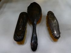 Dressing table set of three silver backed brushes, worn, all hallmarked