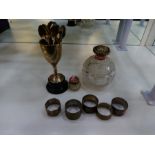 Silver lot comprising of silver napkin rings, two silver topped bottles with cut glass, gilded inter