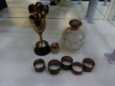 Silver lot comprising of silver napkin rings, two silver topped bottles with cut glass, gilded inter
