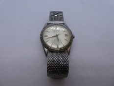 Vintage gents stainless steel wristwatch by Trident, winds and ticks