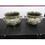 Pair of large and heavy Chinese brass cauldrons with chased and embossed decoration depicting Chines