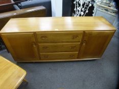 Ercol golden elm sideboard with three central drawers flanked by cupboards