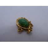 18ct yellow gold pendant with central oval green hardstone, marked 18, on an unmarked yellow metal n