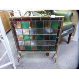Ornate brass fireguard inset with stained glass panels of various colours