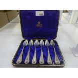 Set of six silver Edwardian teaspoons cased ina Pearce and Sons box, of decorative handled design wi