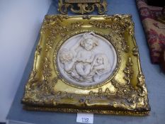 Circular resin plaque depicting cherubs surrounded by square gilt gesso frame, coloured miniature de