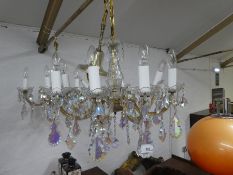 A pair of glass eight branch chandeliers having pendant drops.