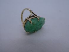 9ct yellow gold dress ring set with green carved stone, size P, gross weight 8.2g