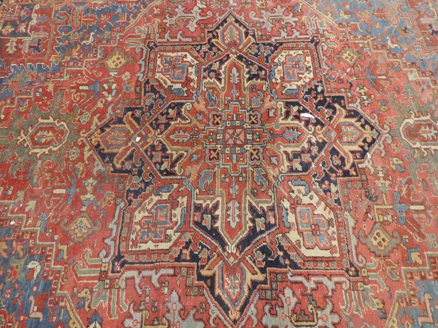 Large middle eastern red ground rug of geometric design with central motif  areas of wear, 129inch x - Image 2 of 4