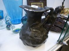 Art Nouveau bronze jug depicting two female nudes in a stream, one forming the handle of the jug, s