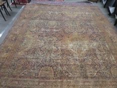 Large middle eastern cream and red decorated carpet, very worn condition, 135inch x 119inch