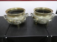 Pair of large and heavy Chinese brass cauldrons with chased and embossed decoration depicting Chines