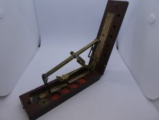 A Coin Balance, c.1800, English, folding pocket guinea scales in mahogany and brass, with turns and