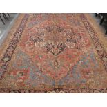 Large middle eastern red ground rug of geometric design with central motif  areas of wear, 129inch x