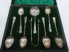 A cased set of Victorian six silver teaspoons, silver sugar tong and silver tea strainer. Hallmarked