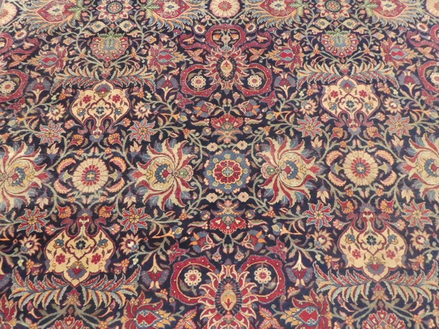 Large blue ground floral bordered oriental carpet 147 x106 inch  areas of wear and small tear - Image 4 of 5