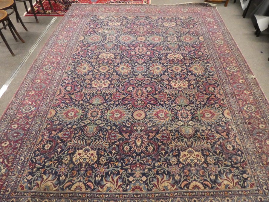 Large blue ground floral bordered oriental carpet 147 x106 inch  areas of wear and small tear