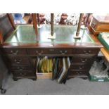 Vintage mahogany pedestal desk with green tooled leather above 9 drawers