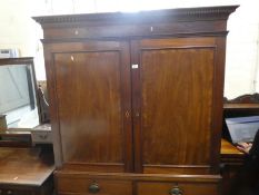 Victorian mahogany linen press with cupboards above drawers on bracket supports