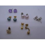 Pair of silver bi plane earrings and other gold and other metal earrings. Some marked 750