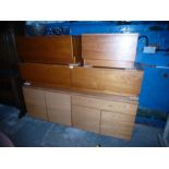 Teak sideboard with cupboards and drawers, similar low two drawer example and a pair of single drawe