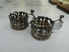 A very interesting, decorative pair of silver Victorian napkin rings of pierced design. With animal