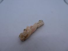 9ct oriental floral design , possibly coral, bar brooch, marked M.Bros 9K