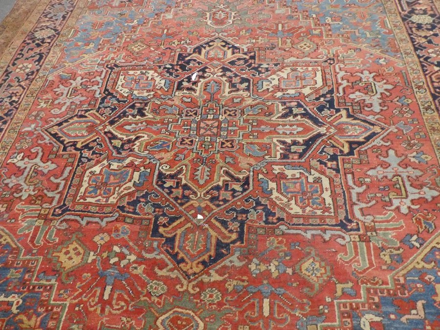 Large middle eastern red ground rug of geometric design with central motif  areas of wear, 129inch x - Image 3 of 4