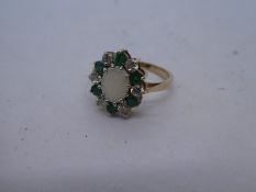 9ct yellow gold cluster ring with central opal surrounded by green and clear stones, size K, 2.5g