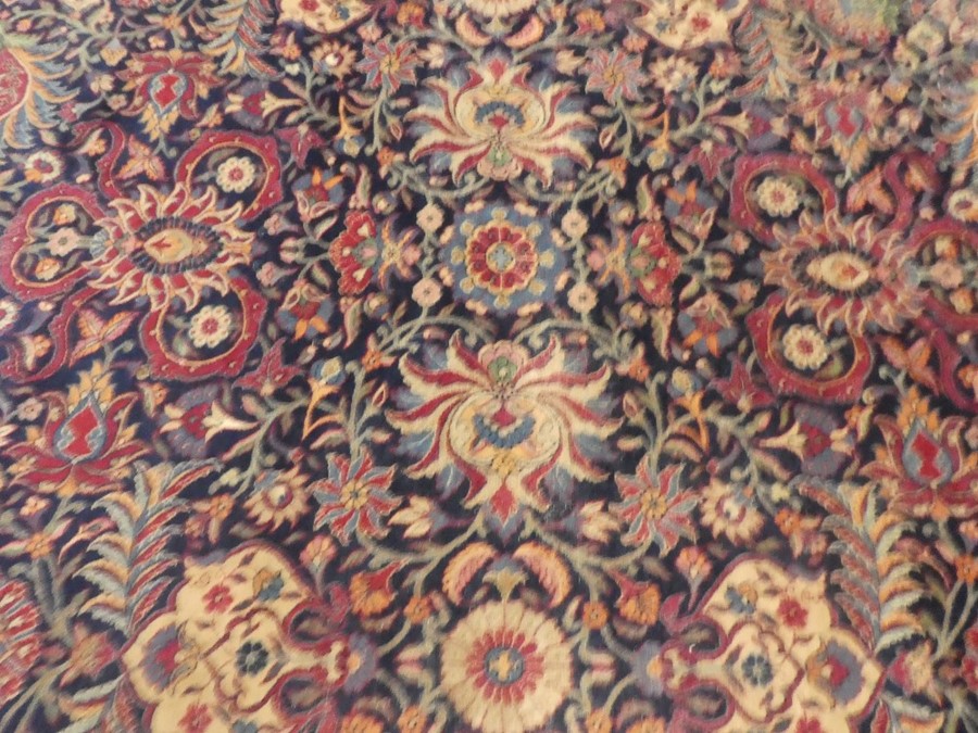 Large blue ground floral bordered oriental carpet 147 x106 inch  areas of wear and small tear - Image 3 of 5