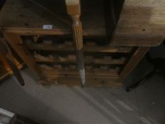 A wax pine wine rack with a base drawer
