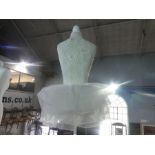 A white painted mannequin with a tutu