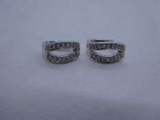 Pair of 18ct white gold huggie diamond set earrings, each earring with 16 small diamonds, hallmarked