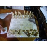 A plaster chess set having oriental style figures