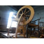 A vintage beech spinning wheel and accessories