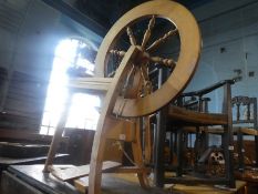 A vintage beech spinning wheel and accessories