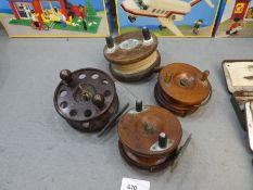 Four fishing reels comprising of two mahogany and an oak example, Star brand
